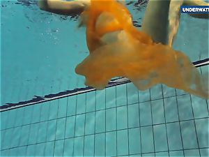 Yellow and red dressed teen underwater